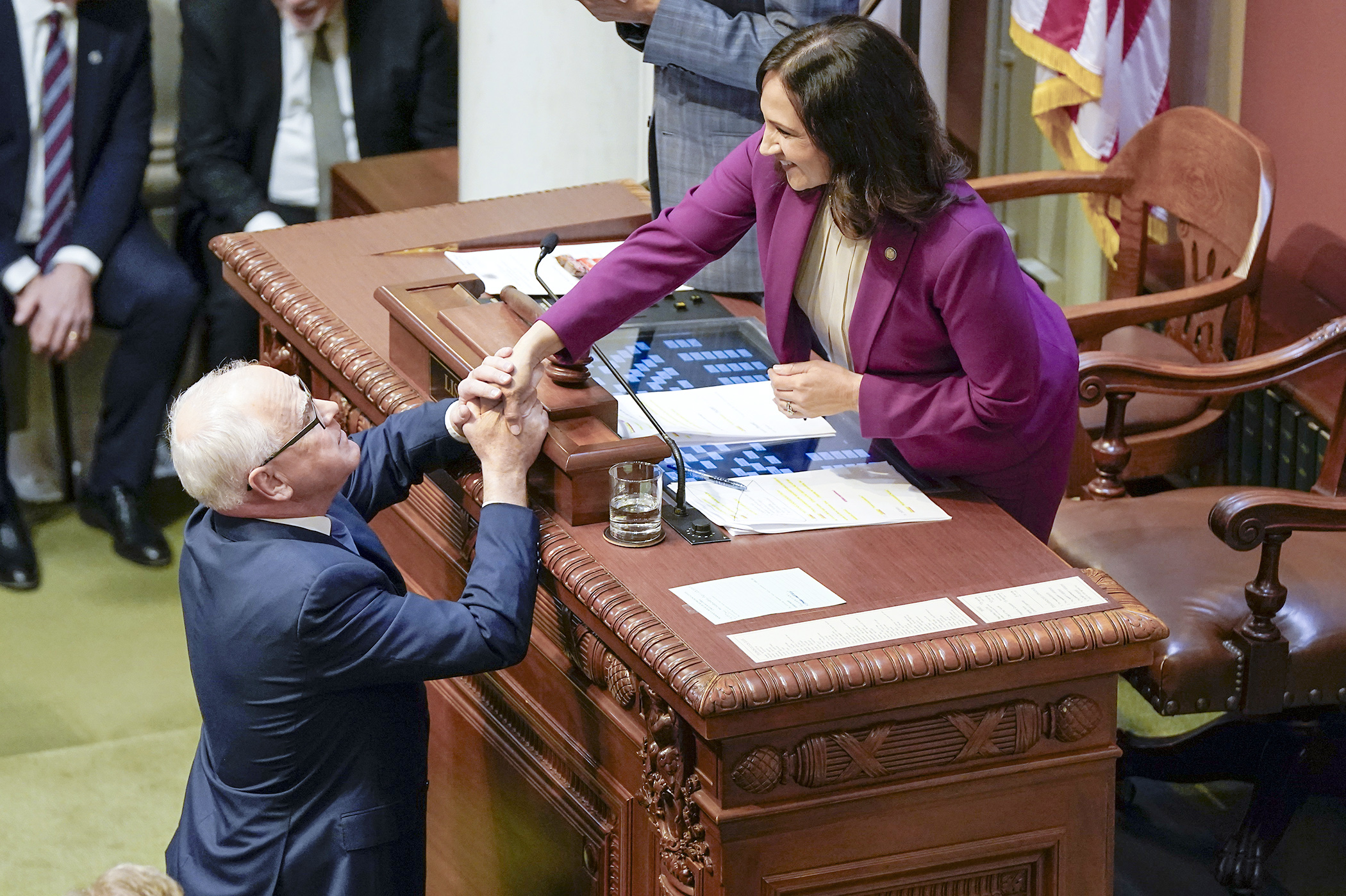 Gov. Tim Walz shakes the hand of House Speaker Lisa Demuth following his State of the State Address to a joint session of the Legislature April 23 in the House Chamber. (Photo by Michele Jokinen)
